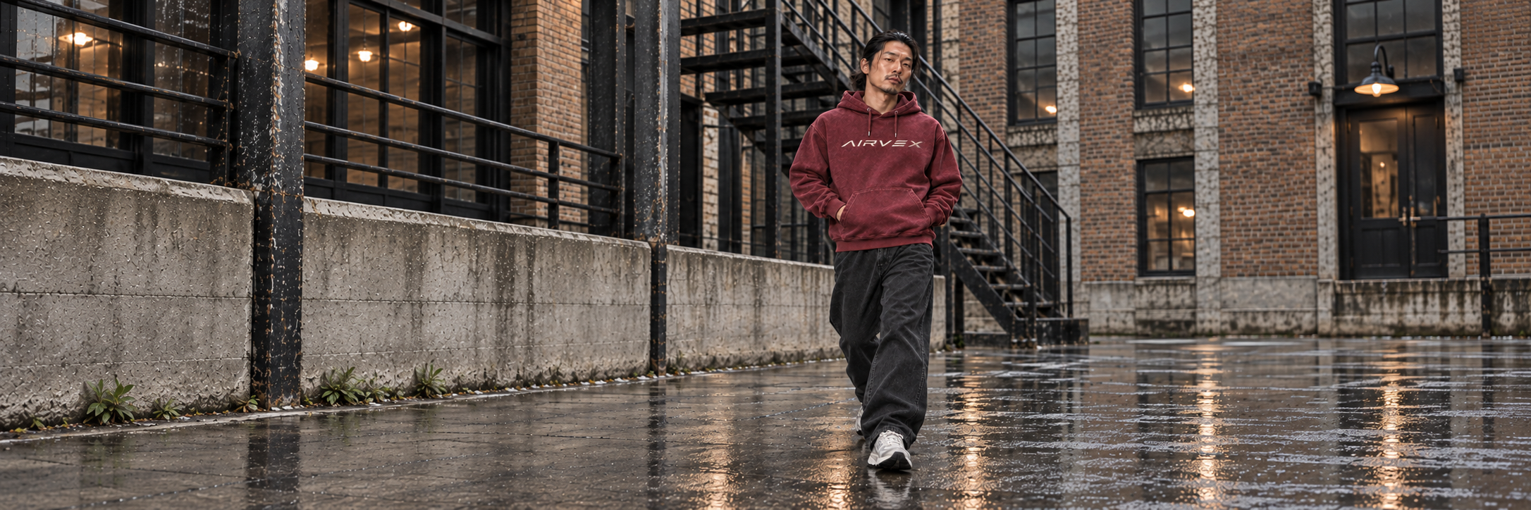 Burgundy Airvex hoodie on a rain-slick street