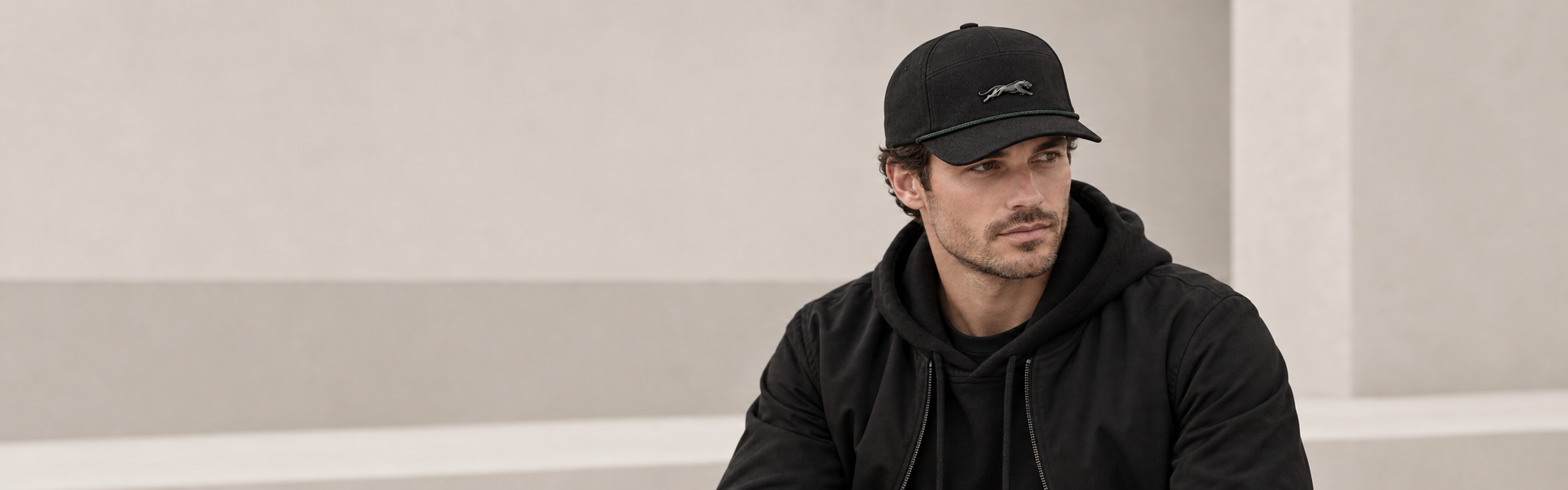 Airvex tonal panther — black hoodie and black cap in soft light